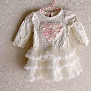 NWOT infant girl dress with tulle overlay.